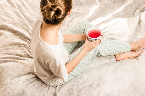 Woman Drinking Tea in Bed
