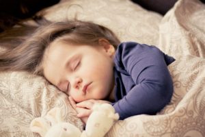 toddler sleeping in bed